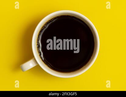Top view of black coffee cup on yellow background Stock Photo