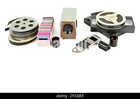 Old videocassettes and video projector with slides isolated on white background. Free space for text. Stock Photo