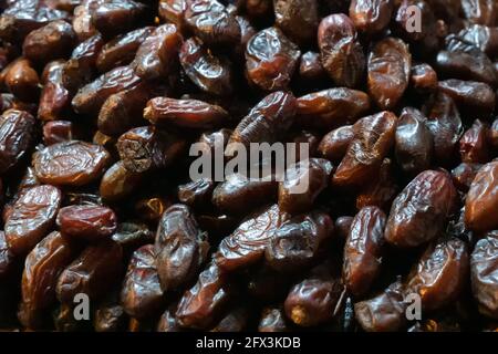 Phoenix dactylifera, commonly known as date or date palm, is a common and famous fruit item - being sold in old delhi market in the evening. Stock Photo