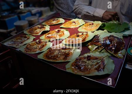 Paan, meaning leaf, is a preparation combining betel leaf with areca nut widely consumed in India. It is chewed for its stimulant and psychoactive eff Stock Photo