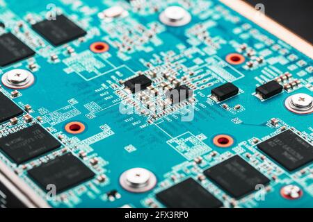 A blue board with chips and a gaming graphics card processor. Progressive cooling system for the video chip, processor and memory. Computer Details Stock Photo