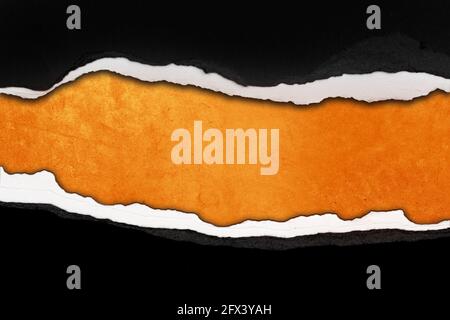 Hole ripped in paper on orange background Stock Photo