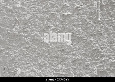 Close-up of an exterior wall painted white but with roughness and imperfections Stock Photo