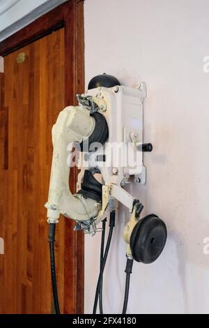 Old vintage telephone set on a ship, close-up against the wall Stock Photo
