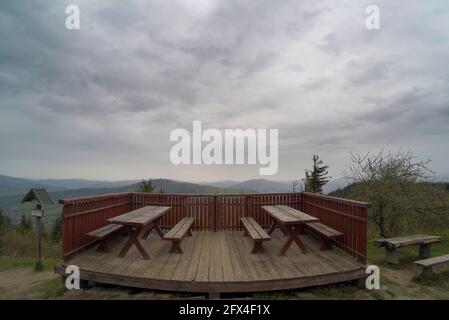 Wide angle view on top of Polish mountains named Luboń Wielki with wooden chairs to sit next to viewpoint located in the region of Beskid Wyspowy clos Stock Photo