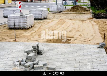view of the pavement construction site, concrete slab pallets and the prepared gravel base Stock Photo