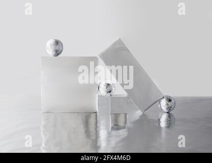 Scene with geometric shapes covered by metallic foil. Stock Photo