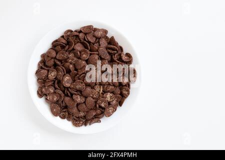 chocolate flakes in bowl isolated on white background, healthy breakfast concept, plate of cornflakes Stock Photo