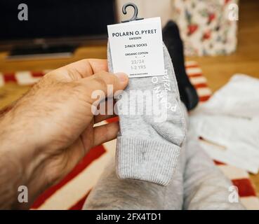 male hand father holding gray made from 97 percent organic cotton infant  baby socks Stock Photo - Alamy