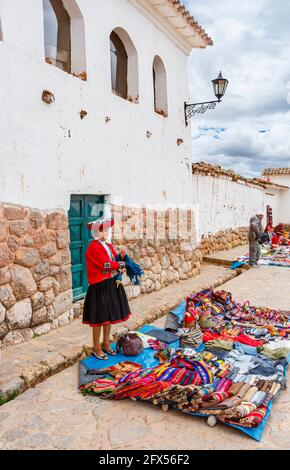 Outdoor textile and souvenir market in the town square of Chinchero, a rustic Andean village in the Sacred Valley, Urubamba, Cusco Region, Peru Stock Photo