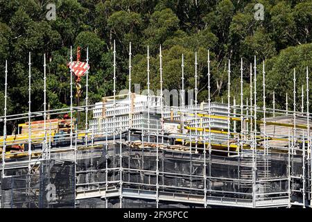 April 10, 2021. Worker loading PVC concrete wall formwork on new social housing at 56-58 Beane St. Gosford, Australia. Part of a building construction Stock Photo