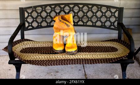 A Pair of Dirty Waterproof Boots Taking a Break Stock Photo