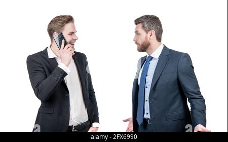 angry boss arguing with smiling employee speaking on phone isolated on white, conflict Stock Photo