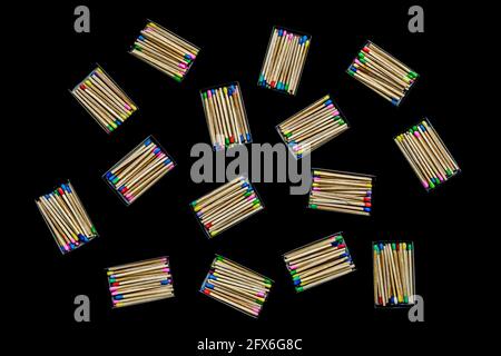 multicolored match sticks in boxes on a black background Stock Photo