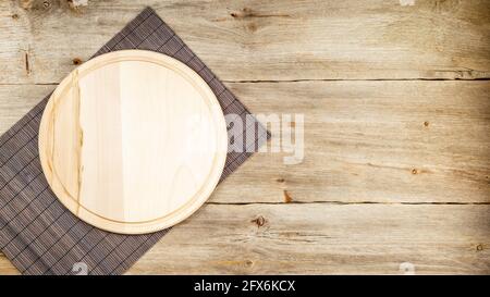 Background with wooden pizza board with bamboo table placemat over grunge rustic background Stock Photo