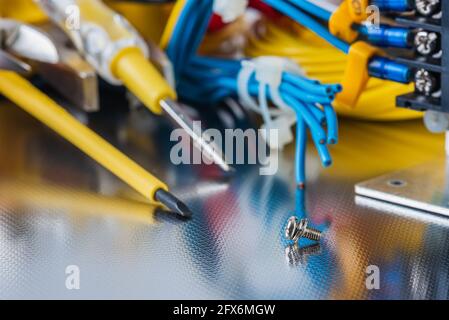 Set of electrical tools and equipment on a metal background, closeup Stock Photo