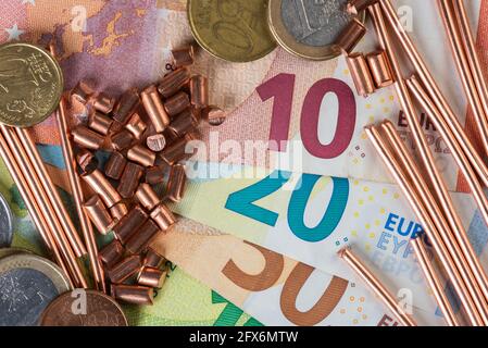 Euro banknotes, coins and scrap of copper wire top view, trading and investing in raw metal materials concept Stock Photo