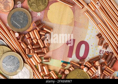 Ten euro banknote, coins and scrap of copper wire top view, trading and investing in raw metal materials concept Stock Photo