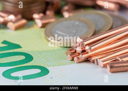 Money and copper raw material, trading and investing in raw metal materials Stock Photo