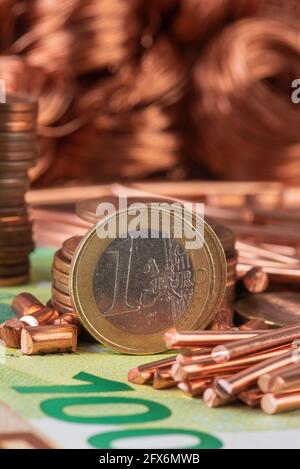 Money and copper raw material, trading and investing in raw metal materials Stock Photo