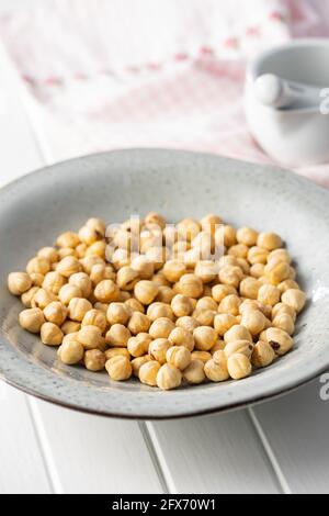 Peeled roasted hazelnut kernels in plate. Stock Photo