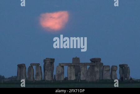 The full moon, known as the 'Super Flower Moon', is seen behind Stonehenge stone circle near Amesbury, Britain, May 26, 2021.  REUTERS/Peter Cziborra