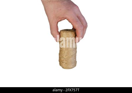 A man is holding a roll of twine. Hand with coiled twine isolated on white background. Stock Photo