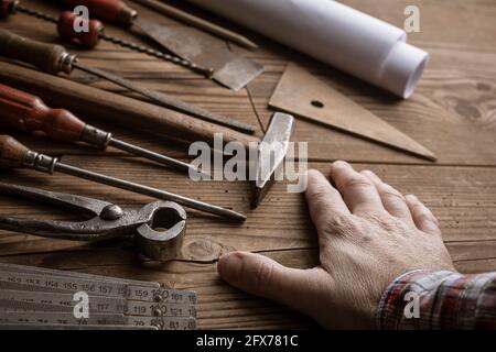 Professional carpenter working on a creative project and vintage tools Stock Photo