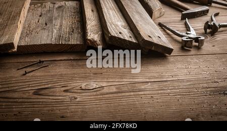Rustic wooden boards and old tools on the carpenter table Stock Photo