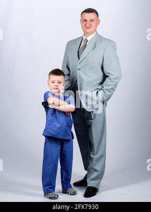 small boy doctor with dad businessman. childhood. trust and values. fathers day. family day. father and son in business suit. male fashion. happy Stock Photo