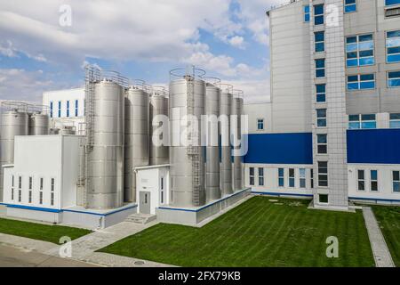 stainless steel tanks at a food processing plant side view. Stock Photo