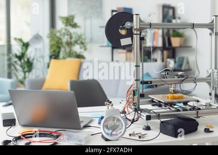 3D printer laptop and tools on a desktop at home Stock Photo