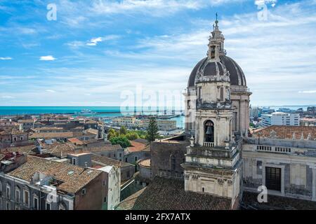 View over the cityscape of Catania on the island of Sicily in Italy with famous cathedral (Cattedrale di Sant'Agata) and harbour Stock Photo