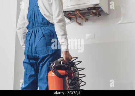 Plumber checking a boiler using professional tools, boiler servicing concept Stock Photo