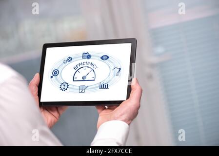 Efficiency concept shown on a tablet held by a man Stock Photo