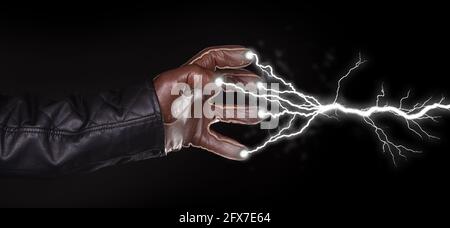 Hand shooting out a bolt of lightning - Dark and mysterious, isolated on black Stock Photo