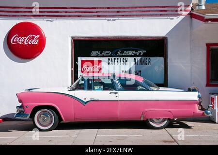 Classic pink Ford Fairlane Crown Victoria car (1950s) parked outside an American dinner along historic Route 66, Williams, Arizona, USA Stock Photo