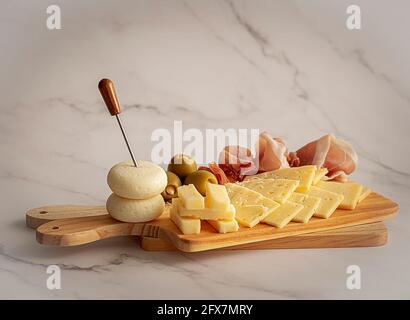 Cheese appetizer with bacon and olives Stock Photo