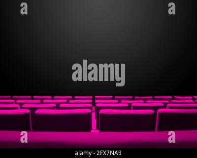 Cinema movie theatre with pink seats rows and a black copy space background Stock Photo