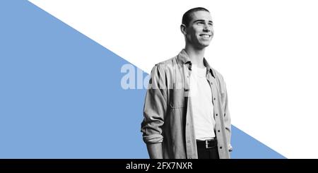 Cheerful young man standing against dual tone background. Cheerful young man looking away. Stock Photo