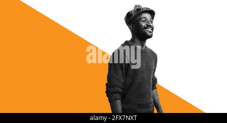 Cheerful man isolated on white background wearing a cap. Side view of african american man in winter woollen clothes. Stock Photo