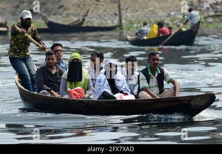 Boat taxis crossing the Buriganga river in Dhaka, Bangladesh.