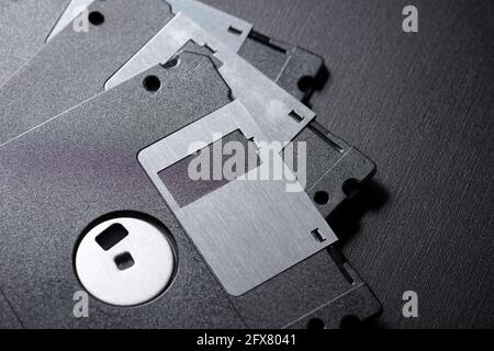 Old floppy disks on a black table. Stock Photo