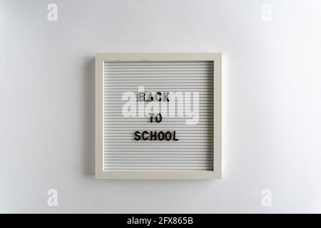 Letterboard with Words That Spell Back To School, on a white background, horizontal Stock Photo