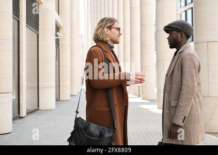 Young men talking during a meeting on the street Stock Photo