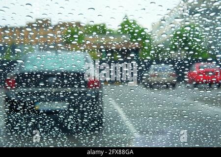 Rainy days. Driving in rain, rainy weather. Rain drops on window. Stock Photo