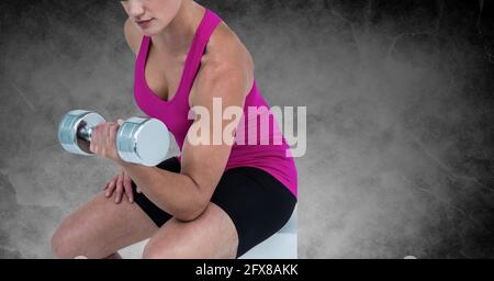 Composition of midsection of strong caucasian woman lifting dumbbells Stock Photo