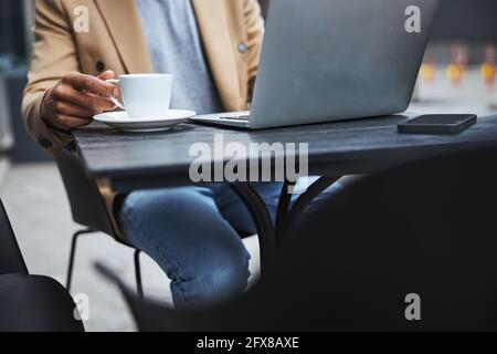 Focused photo on male hand talking cup Stock Photo
