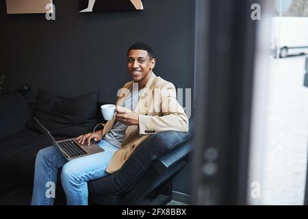 Positive delighted male person being deep in thoughts Stock Photo