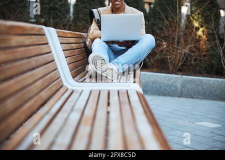 Focused photo on cheerful man staring at his laptop Stock Photo